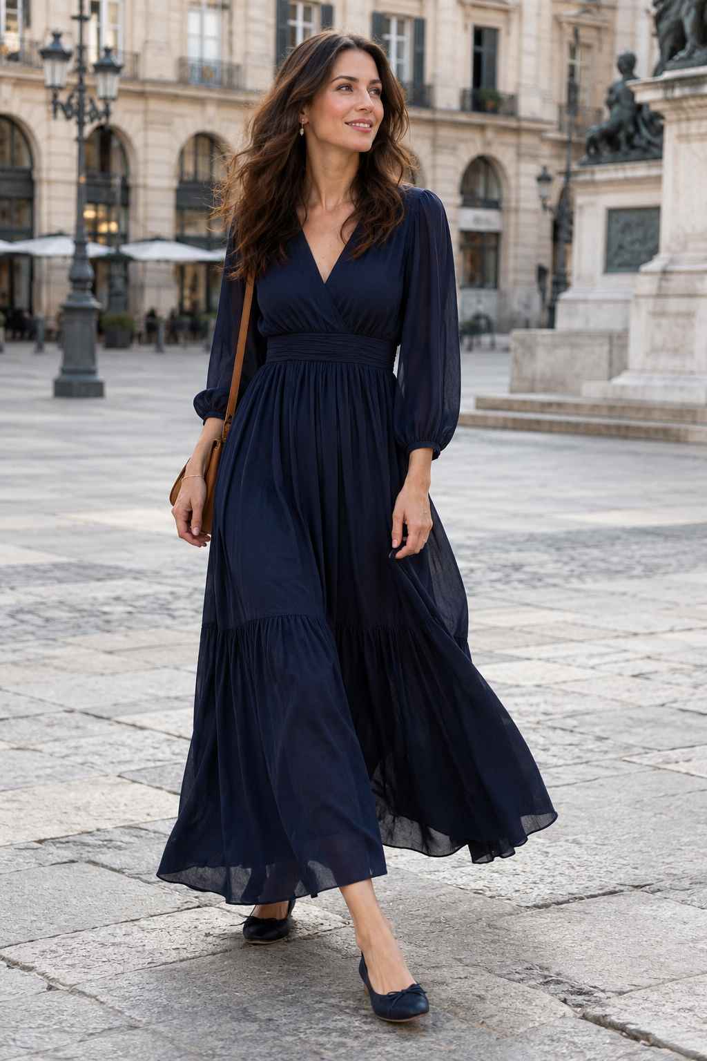 Adult model in a navy maxi dress with flat shoes on a city plaza